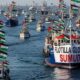 Embarcaciones de la flotilla humanitaria a Gaza zarpan desde el puerto de Barcelona con banderas palestinas y activistas a bordo.